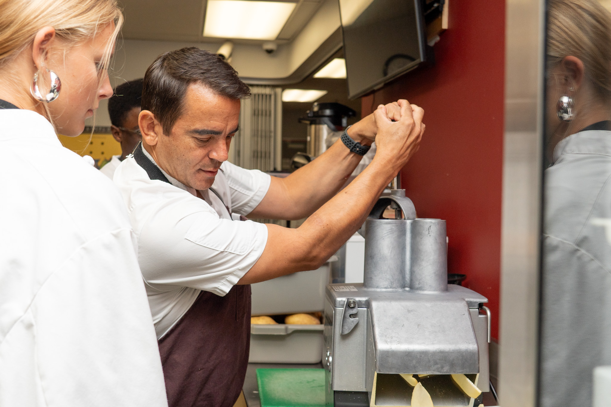 2026-10 CHEF RANDLE AWARD-12 Chef Trevor Randle assists students in the Maple Ridge Secondary teaching kitchen.
