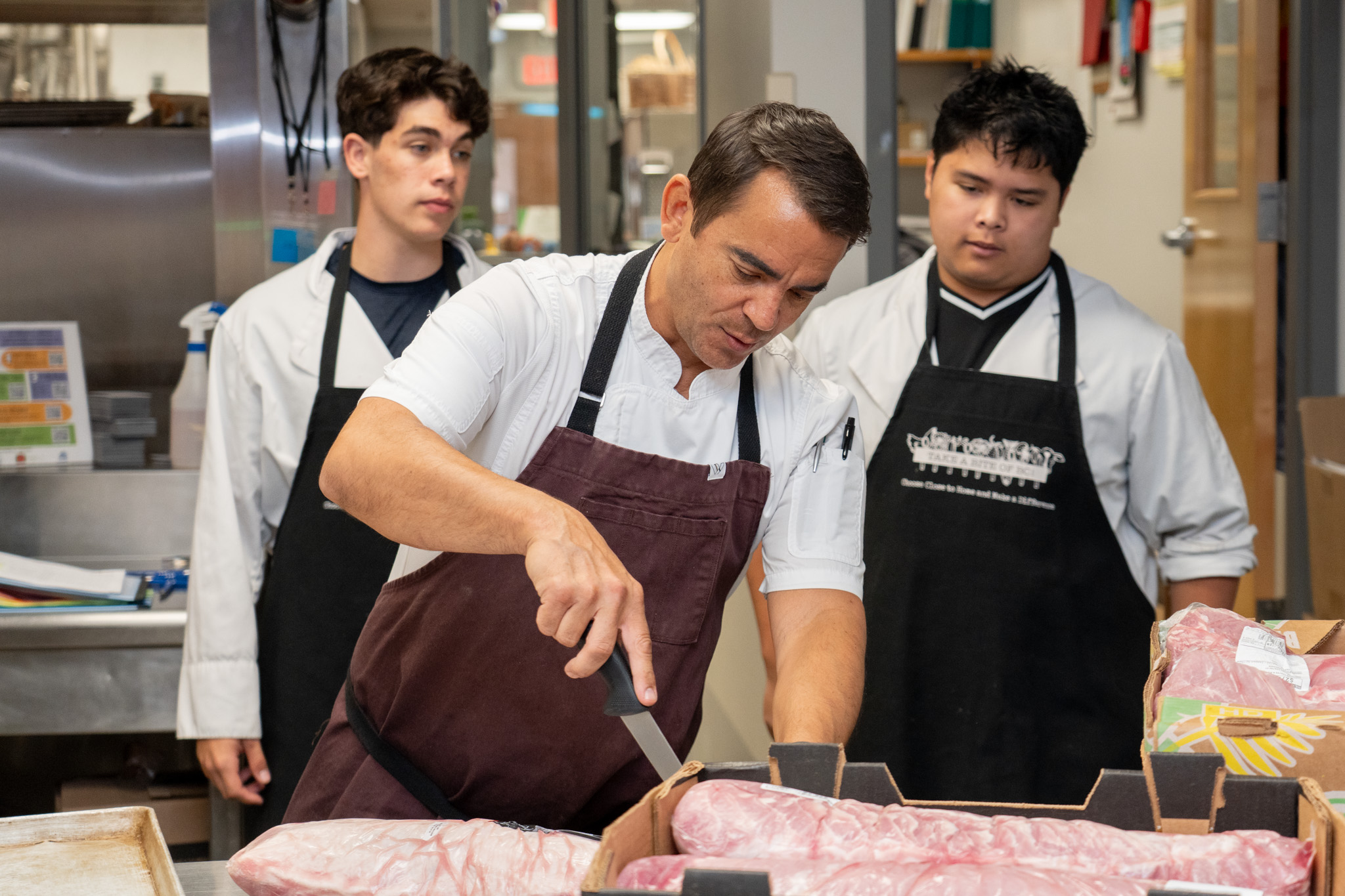 2026-10 CHEF RANDLE AWARD-4 Chef Trevor Randle assists students in the Maple Ridge Secondary teaching kitchen.
