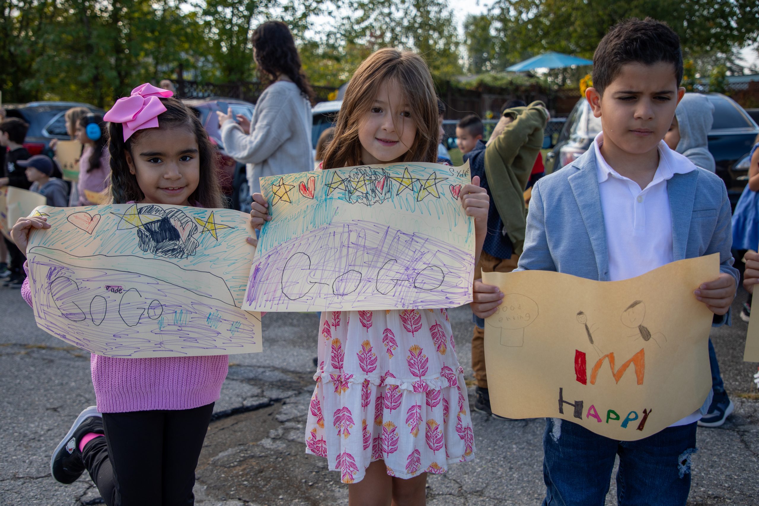 Albion Cops for Cancer-23 Students hold up signs at Albion Elementary cheering on the Cops for Cancer Tour de Coast.