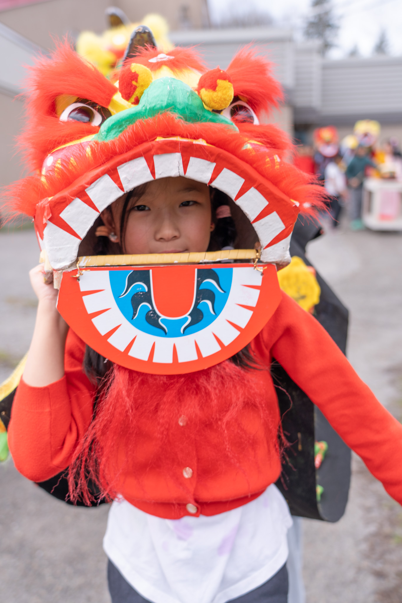 Albion Elementary student in a lion head for the Lunar New Year parade.
