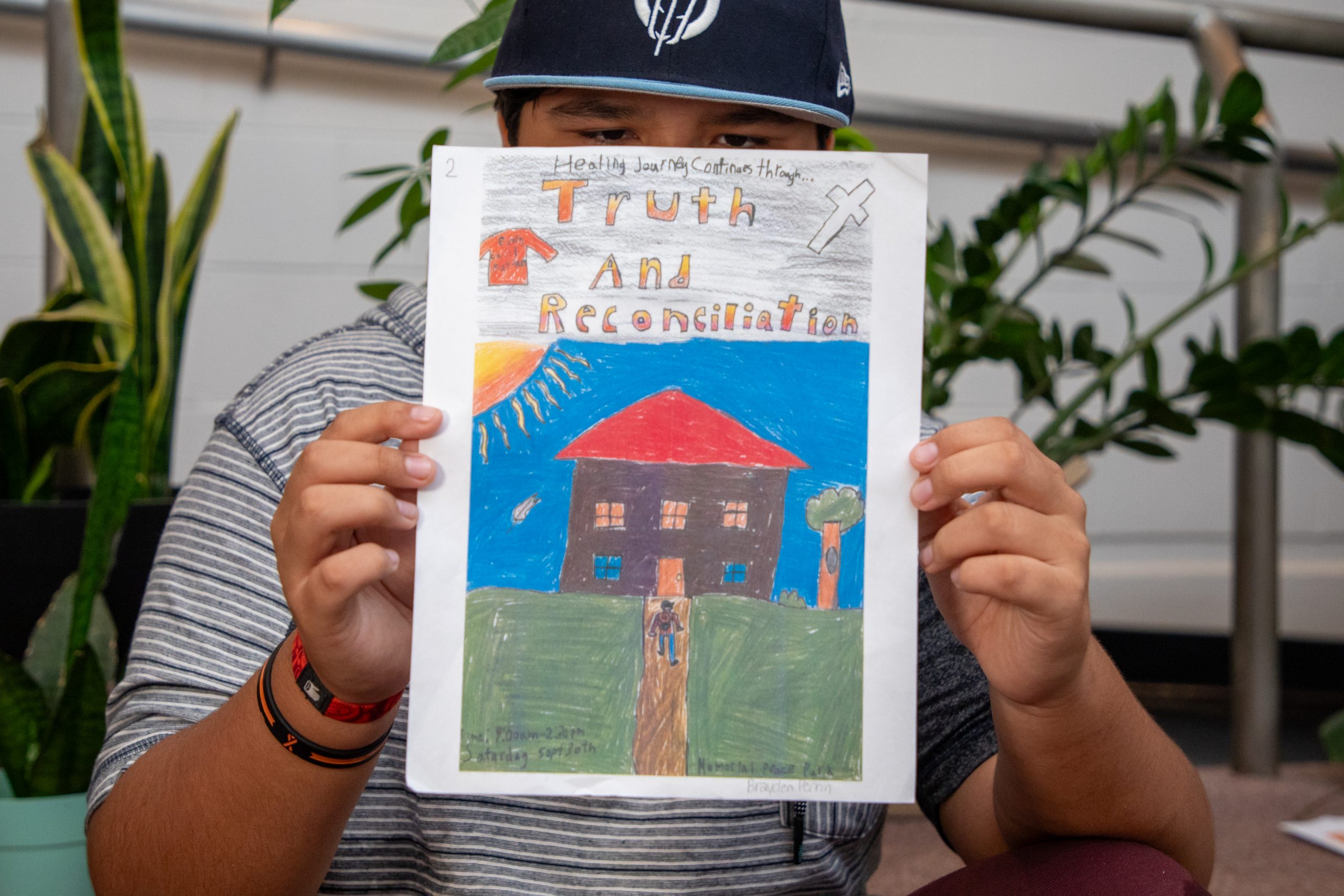 Grade 7 student Brayden holds up his poster for the National Day for Truth and Reconciliation.
