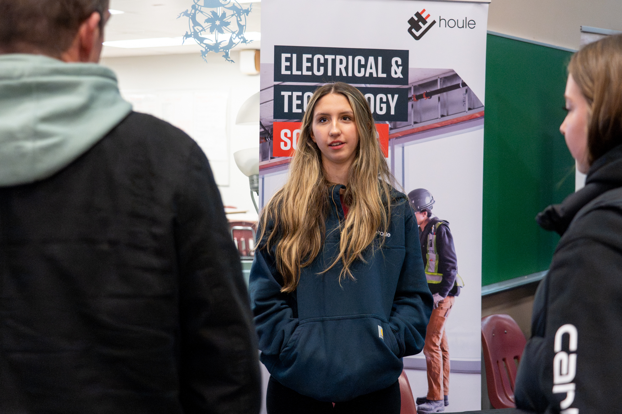 SD42 Trades Showcase 2026-106 Houle Electric representative talks to families at the 2026 SD42 Trades Showcase.