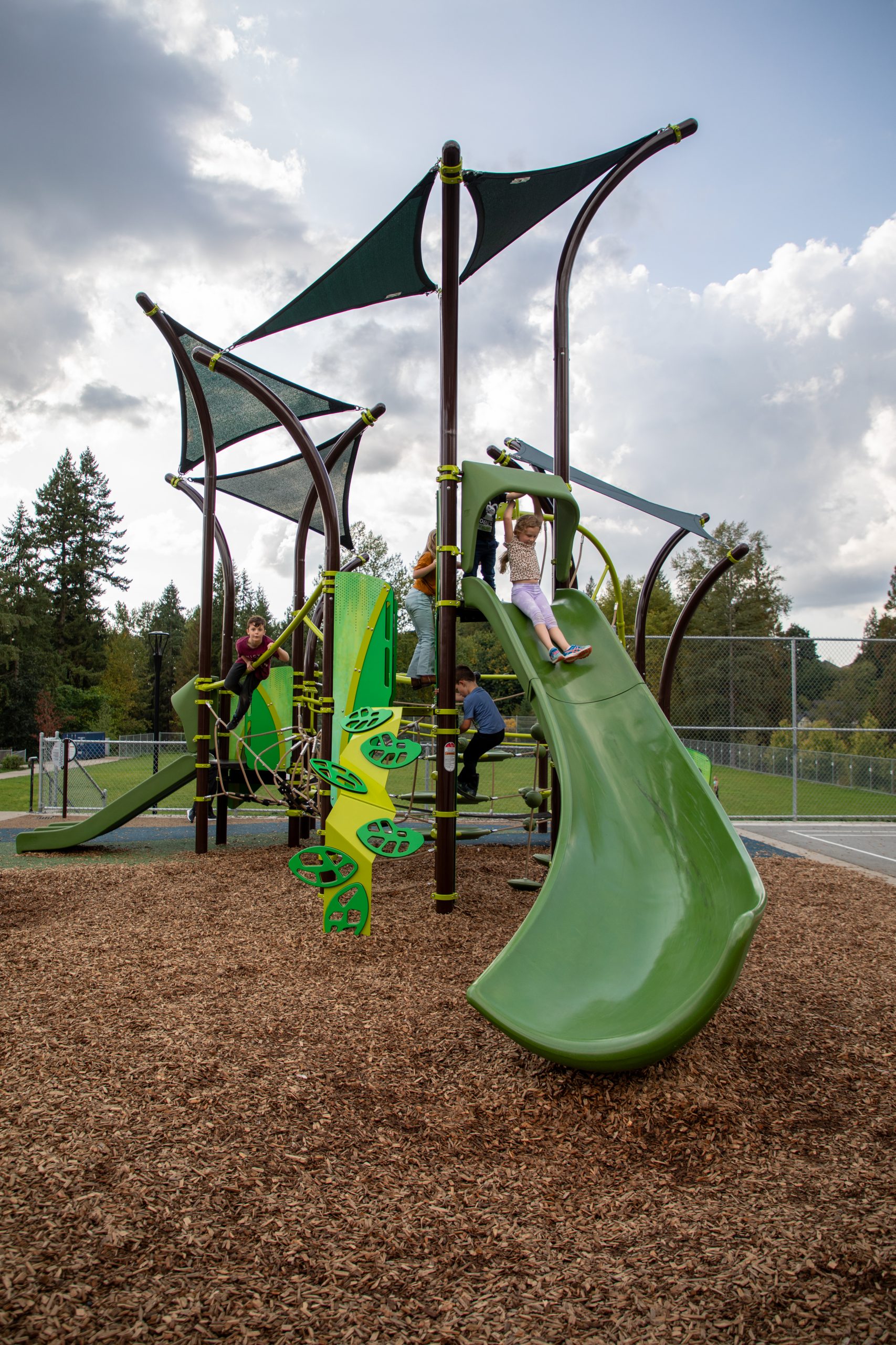 Students play on the new playground at c̓əsqənelə Elementary.